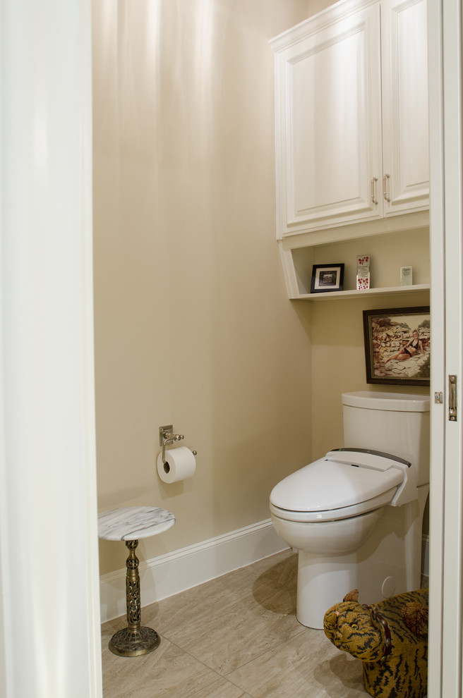 Design ideas for a large mediterranean powder room in Austin with raised-panel cabinets, white cabinets, a one-piece toilet, beige tile, marble, beige walls, travertine floors, an undermount sink, granite benchtops and beige floor.