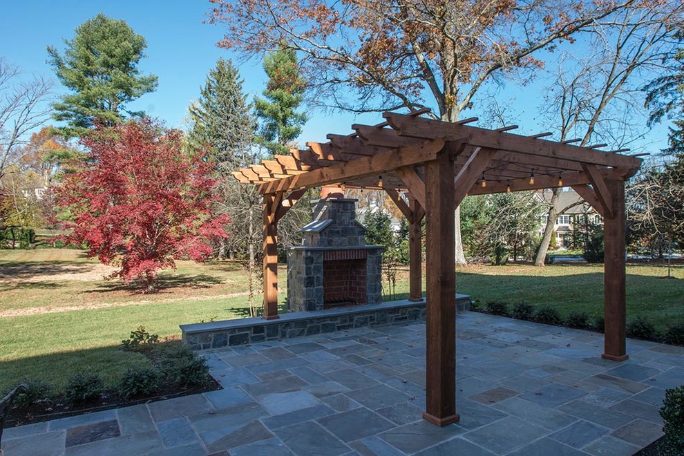 Photo of a mid-sized traditional backyard patio in Philadelphia with with fireplace, tile and a pergola.