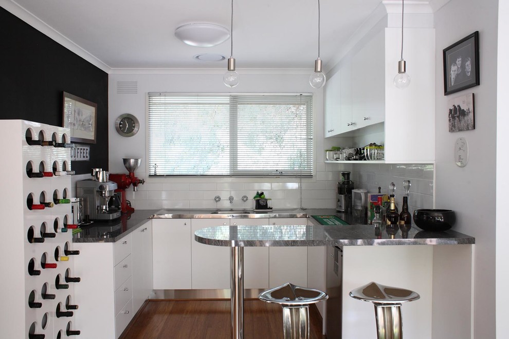 Mid-sized transitional open concept kitchen in Melbourne with black walls and bamboo floors.