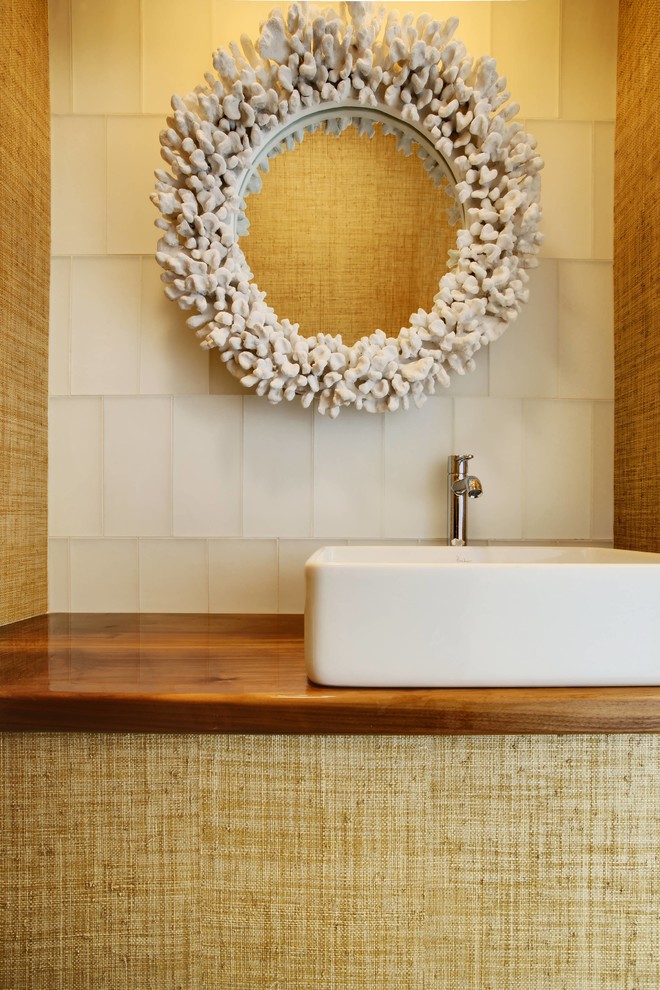 Photo of a beach style powder room in Other with a vessel sink, white tile and glass tile.