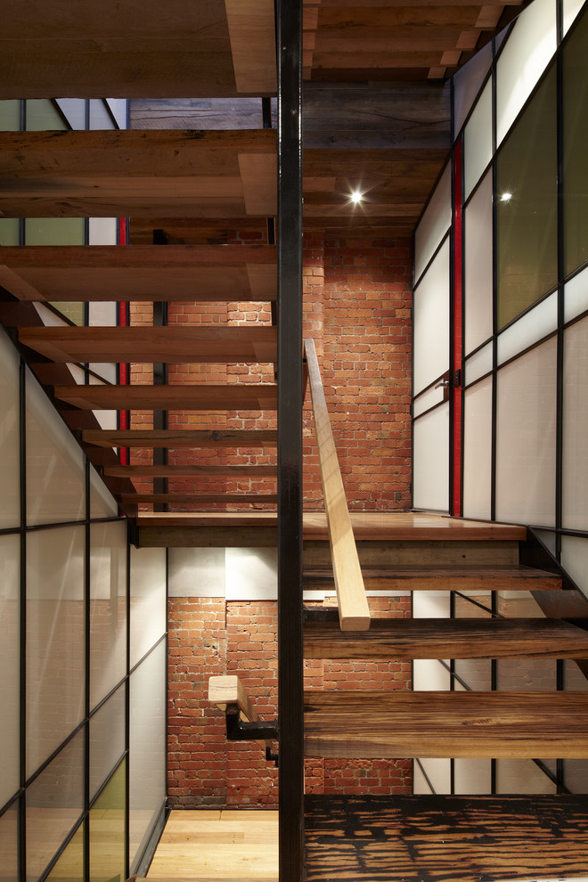 Design ideas for an industrial wood u-shaped staircase in Melbourne with open risers.