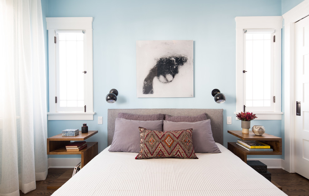 Inspiration for a transitional guest bedroom in Los Angeles with blue walls and dark hardwood floors.