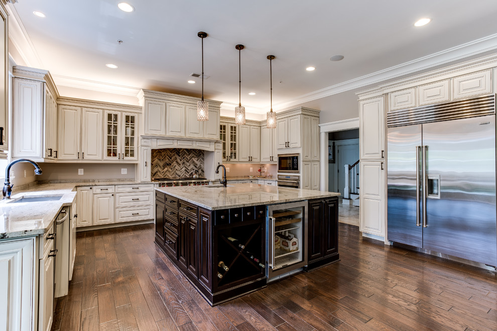 Example of a large u-shaped medium tone wood floor eat-in kitchen design in DC Metro with a drop-in sink, raised-panel cabinets, distressed cabinets, granite countertops, beige backsplash, glass tile backsplash, stainless steel appliances and two islands