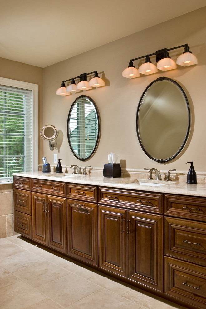 Large traditional master bathroom in Boston with a drop-in sink, raised-panel cabinets, medium wood cabinets, granite benchtops, beige tile, stone tile, beige walls and ceramic floors.