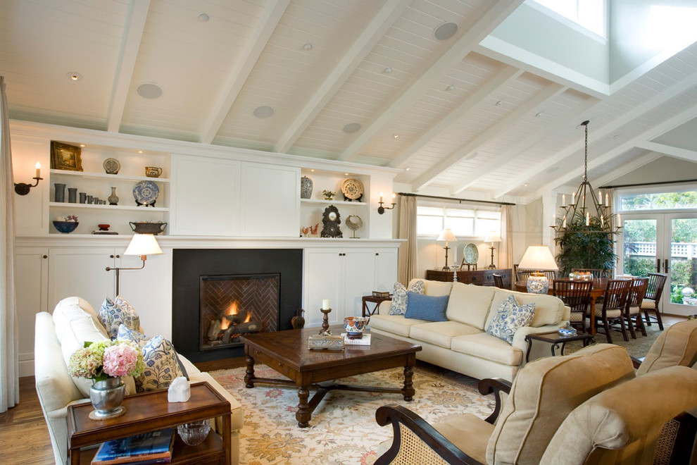 Photo of a contemporary living room in San Francisco with a metal fireplace surround and a concealed tv.