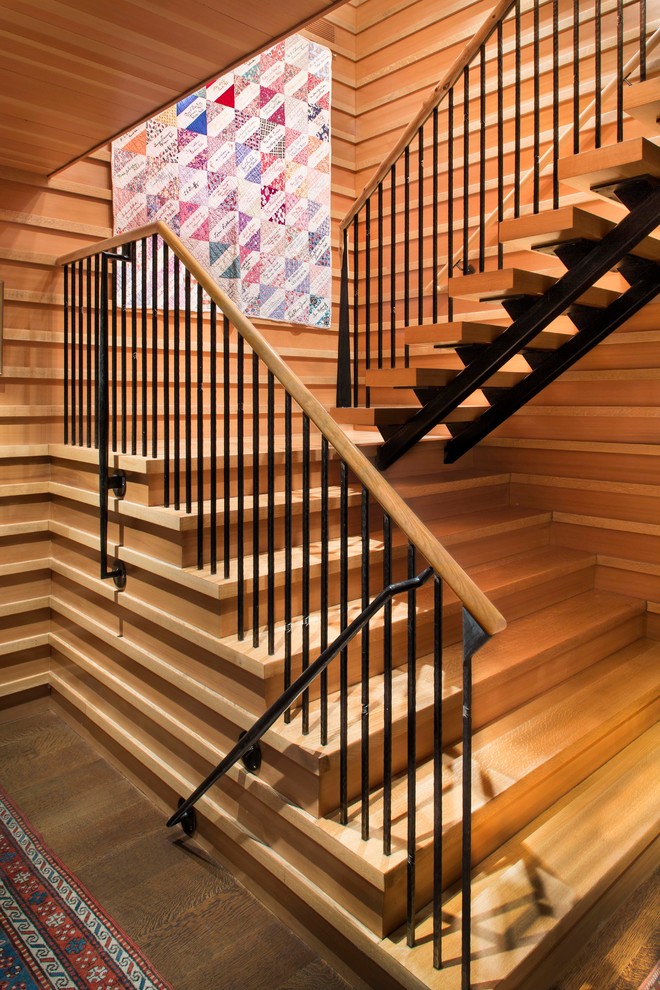 Photo of a large modern wood l-shaped staircase in New York with wood risers.