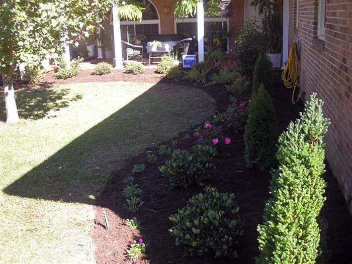 This is an example of a mid-sized full sun backyard landscaping.