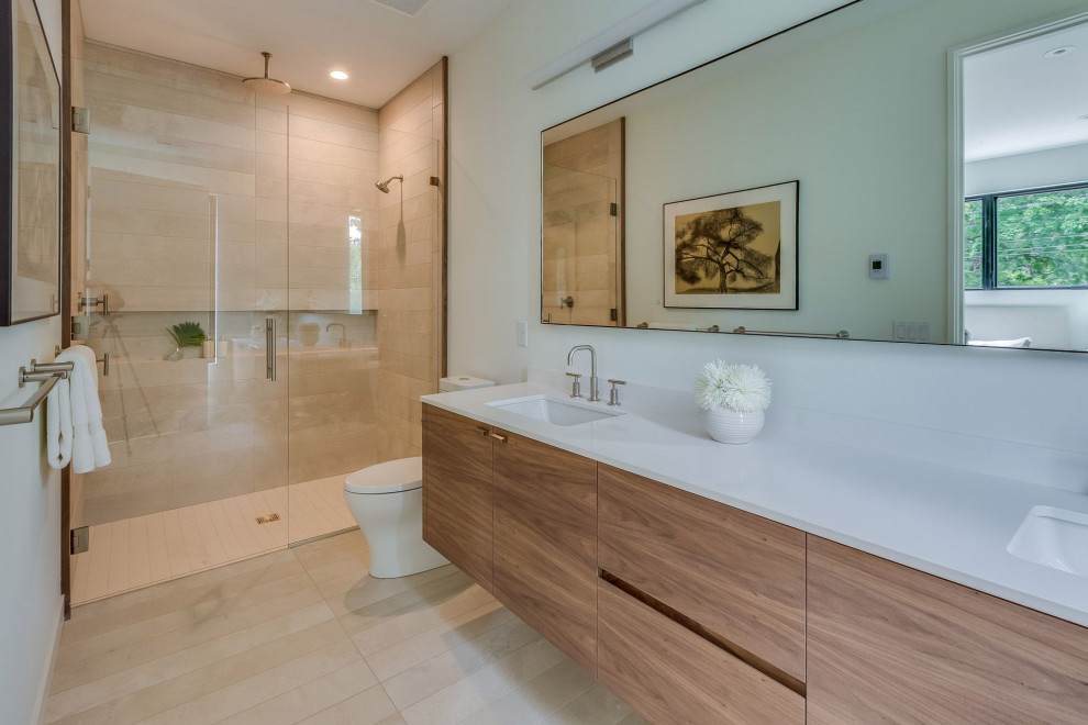 Alcove shower - modern beige tile beige floor and double-sink alcove shower idea in Minneapolis with flat-panel cabinets, medium tone wood cabinets, an undermount sink, a hinged shower door, white countertops and a floating vanity