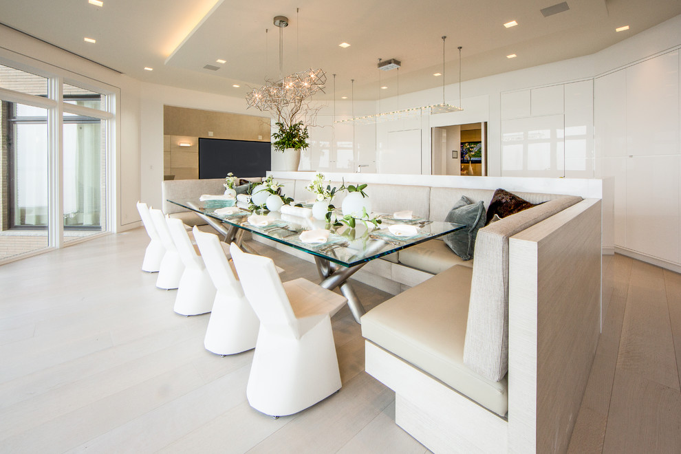 Photo of an expansive contemporary kitchen/dining combo in Cleveland with light hardwood floors.