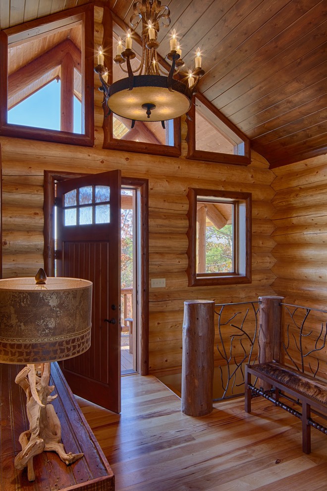 This is an example of a country entryway in Dallas with a single front door and a dark wood front door.