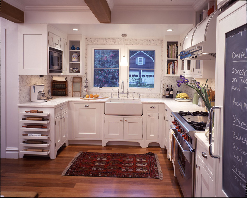 Traditional kitchen in New York with stainless steel appliances and a farmhouse sink.