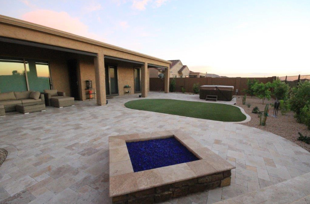 Inspiration for a small traditional backyard full sun garden for summer in Phoenix with brick pavers and a fire feature.
