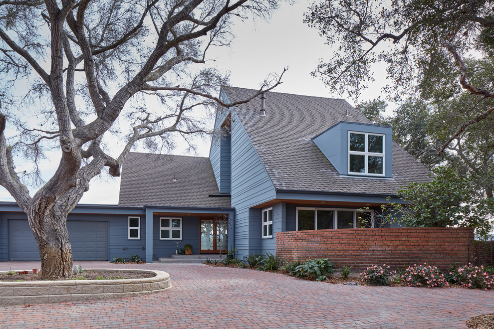 This is an example of a large scandinavian two-storey grey house exterior in San Luis Obispo with concrete fiberboard siding, a gable roof and a shingle roof.