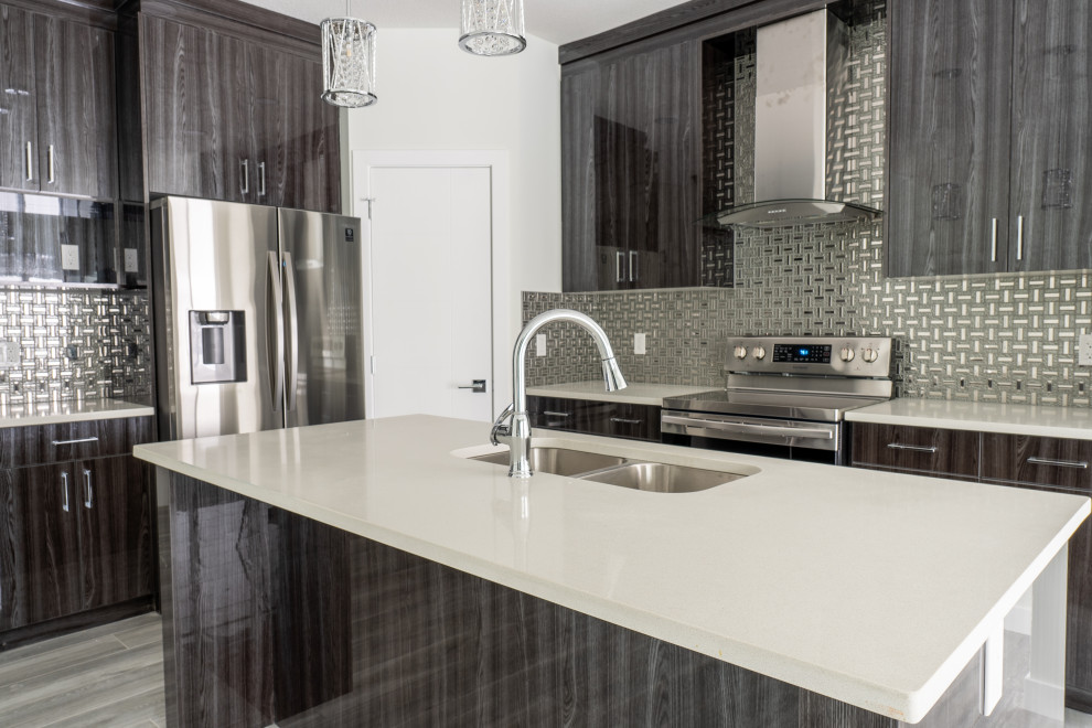 Eat-in kitchen - mid-sized contemporary porcelain tile and gray floor eat-in kitchen idea in Edmonton with a double-bowl sink, flat-panel cabinets, dark wood cabinets, metallic backsplash, stainless steel appliances, an island and white countertops