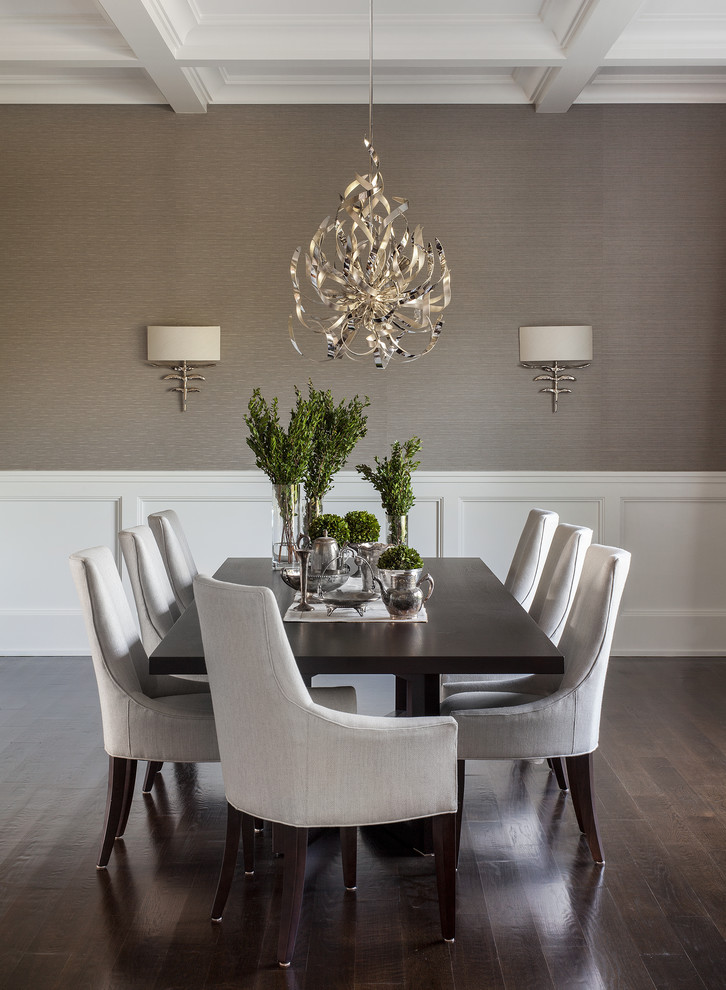 Photo of a transitional dining room in New York with grey walls, dark hardwood floors and decorative wall panelling.