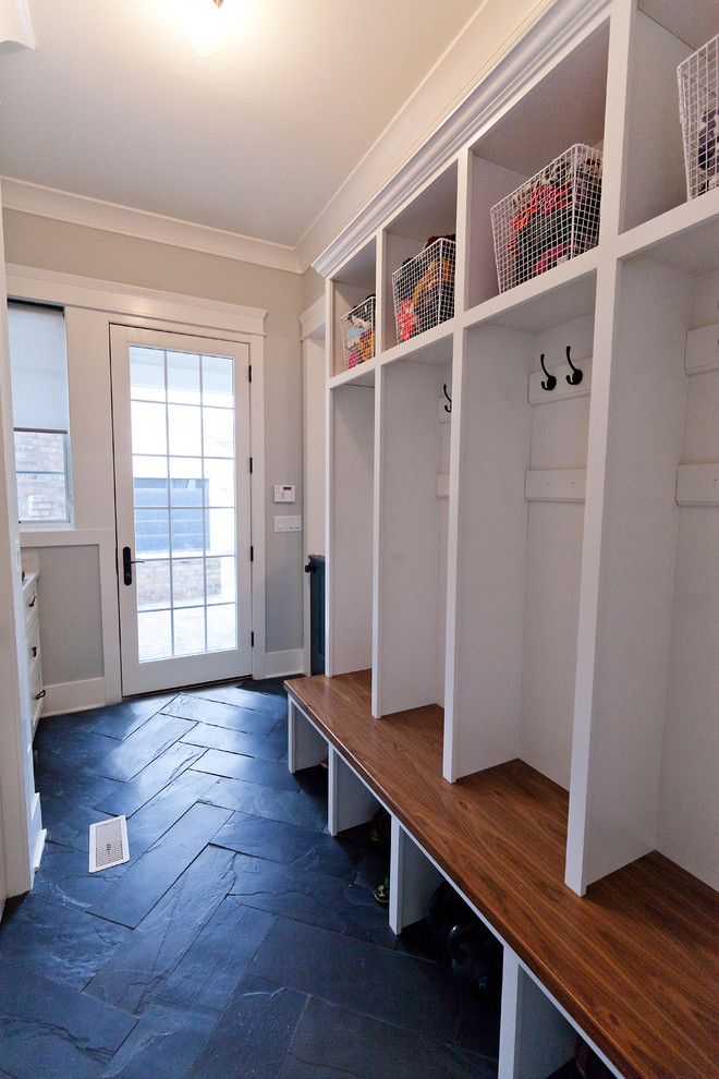 This is an example of a mid-sized transitional mudroom in Chicago with grey walls, slate floors, a single front door, a white front door and black floor.