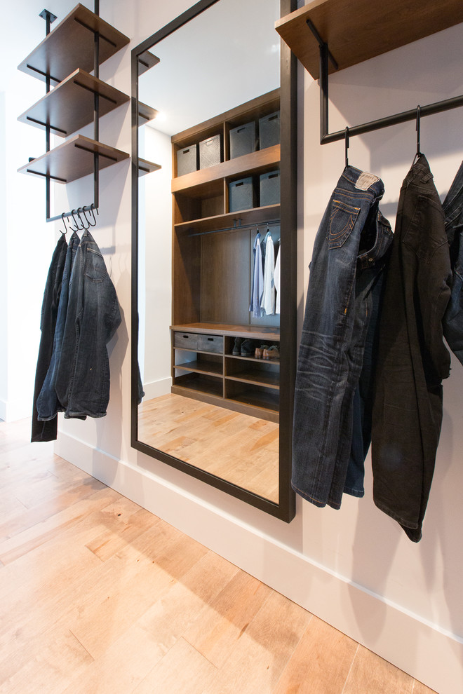 Design ideas for a mid-sized contemporary men's walk-in wardrobe in Orlando with open cabinets, dark wood cabinets and light hardwood floors.