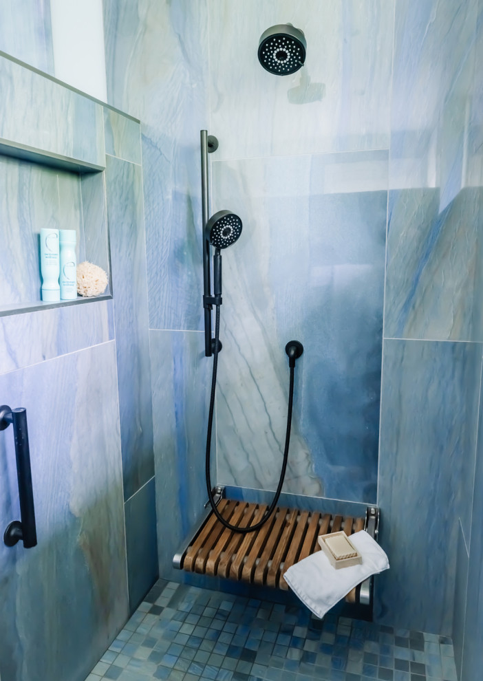 Photo of a modern master bathroom in Cedar Rapids with a corner tub, blue tile, blue walls, blue floor and porcelain floors.