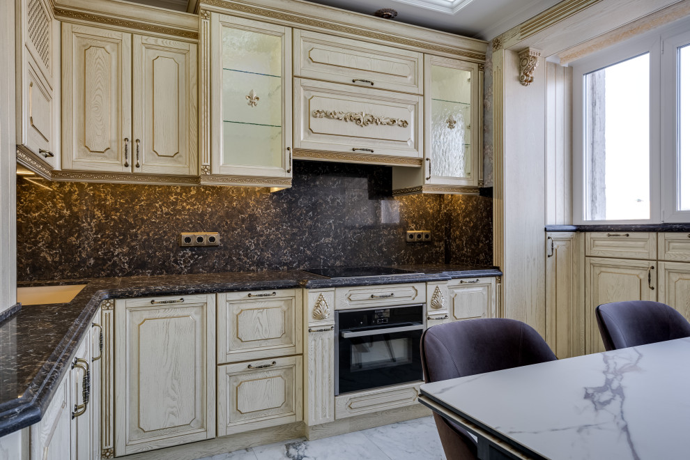Inspiration for a large traditional l-shaped eat-in kitchen in Moscow with beaded inset cabinets, beige cabinets, quartz benchtops, black splashback, engineered quartz splashback, black appliances, ceramic floors, no island, white floor and black benchtop.