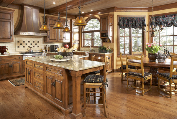 Design ideas for a large traditional l-shaped eat-in kitchen in Minneapolis with raised-panel cabinets, medium wood cabinets, granite benchtops, medium hardwood floors and with island.