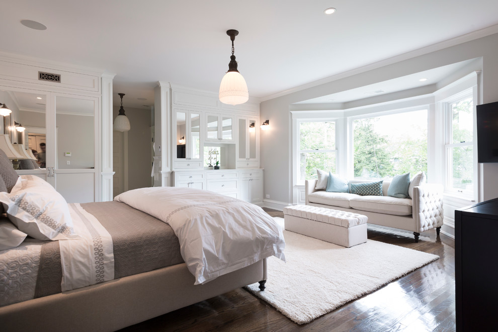 Photo of a large transitional master bedroom in Chicago with grey walls, no fireplace and dark hardwood floors.