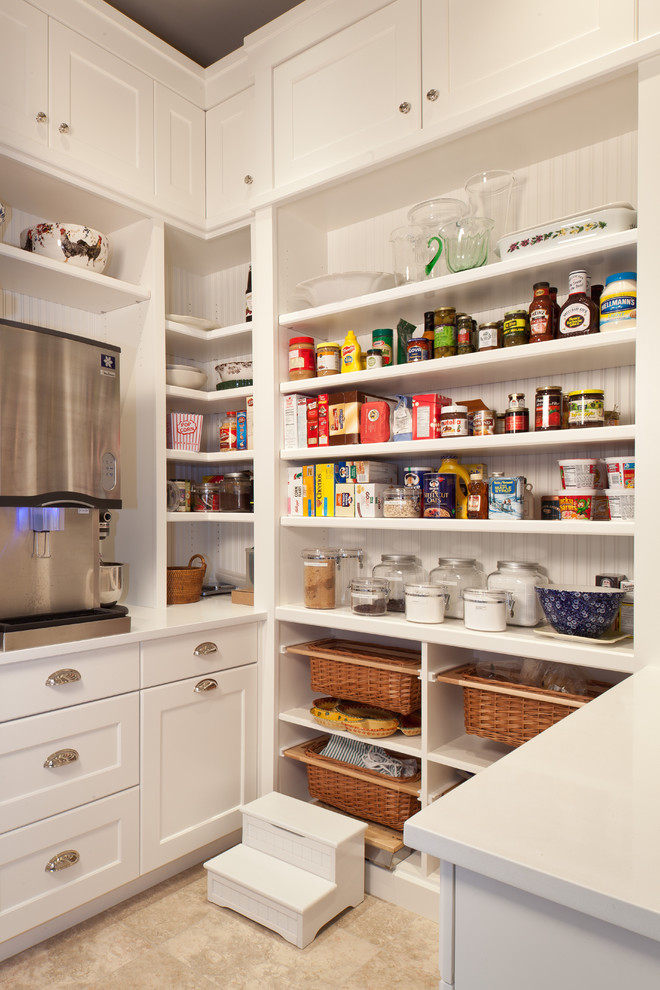 Photo of a traditional kitchen pantry in Miami with open cabinets and white cabinets.
