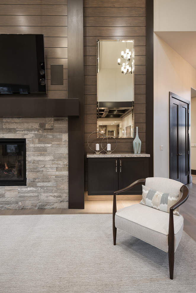 This is an example of a large modern open concept family room in Salt Lake City with beige walls, carpet, a standard fireplace, a wall-mounted tv and a stone fireplace surround.