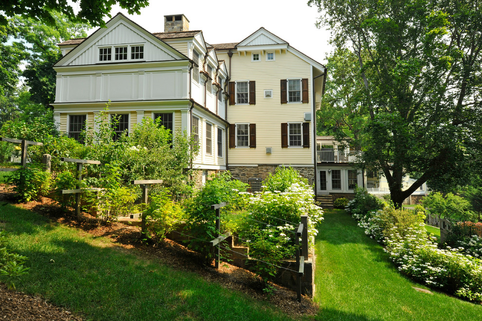 Example of a classic three-story mixed siding exterior home design in New York