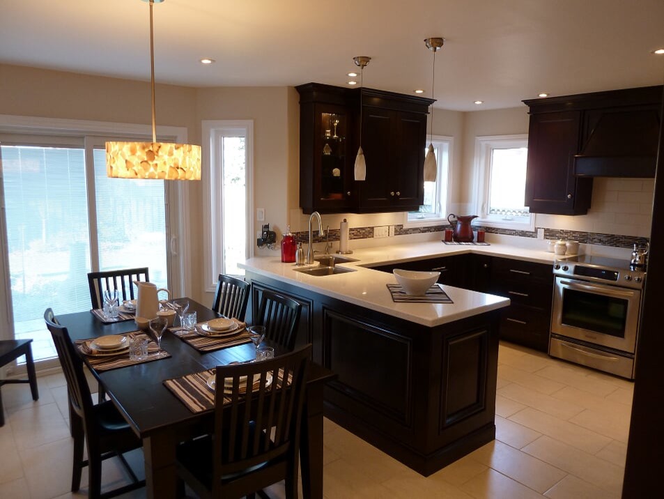 Transitional porcelain tile and beige floor eat-in kitchen photo in Toronto with a double-bowl sink, shaker cabinets, dark wood cabinets, quartz countertops, white backsplash, subway tile backsplash, stainless steel appliances and white countertops