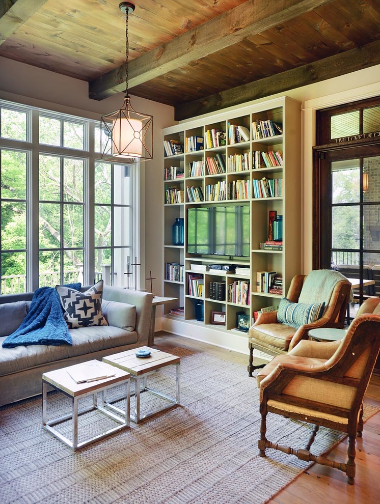 Design ideas for an eclectic formal enclosed living room in Nashville with beige walls, medium hardwood floors and orange floor.