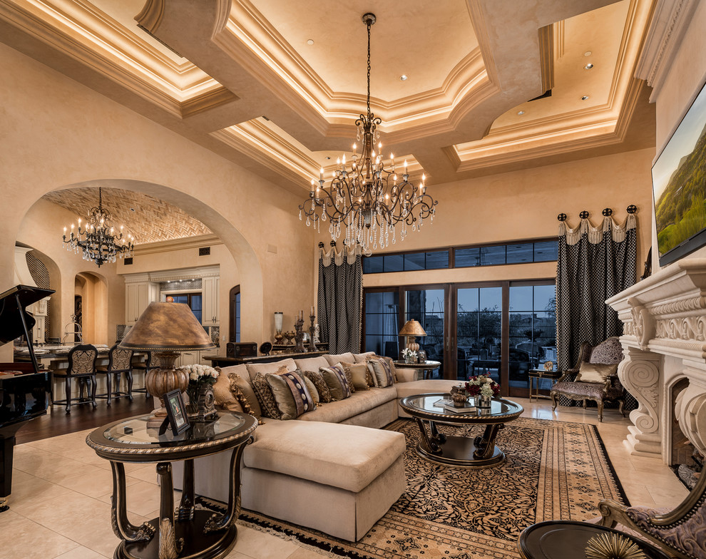 Inspiration for an expansive mediterranean formal open concept living room in Phoenix with beige walls, porcelain floors, a standard fireplace, a stone fireplace surround, a built-in media wall, beige floor and coffered.