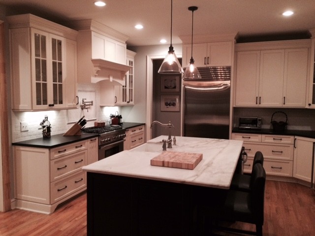 Transitional kitchen photo with shaker cabinets, white cabinets and an island