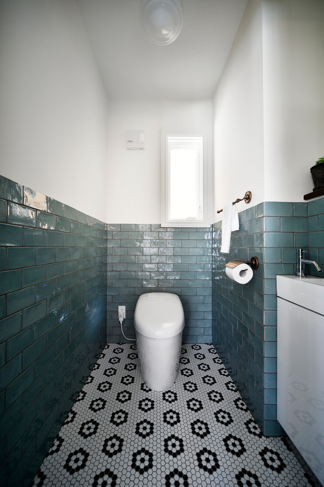 Inspiration for an industrial powder room in Other with multi-coloured floor.