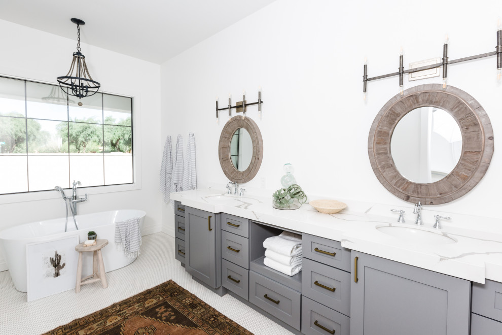 Photo of a transitional bathroom in Phoenix with shaker cabinets, grey cabinets, a freestanding tub, white walls, mosaic tile floors, an undermount sink, white floor, white benchtops, a double vanity and a built-in vanity.