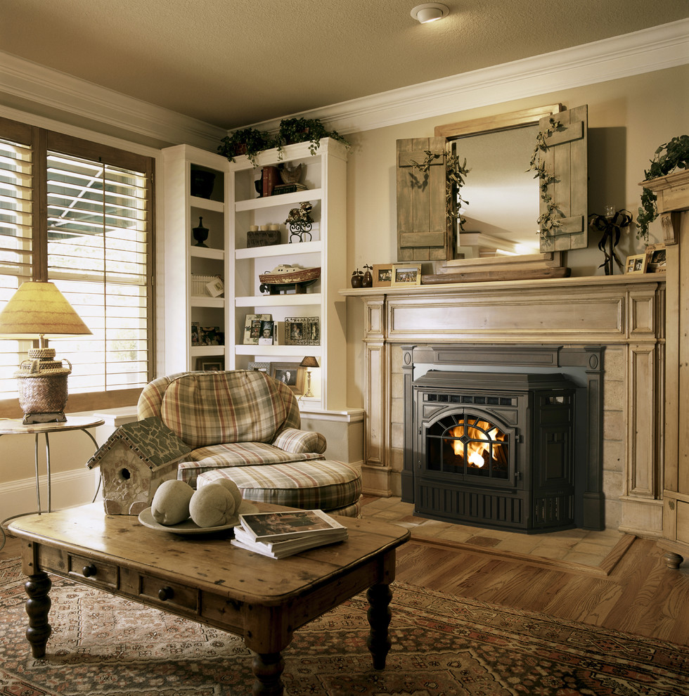 Design ideas for a mid-sized traditional formal enclosed living room in Seattle with beige walls, medium hardwood floors, a standard fireplace, a wood fireplace surround, no tv and beige floor.