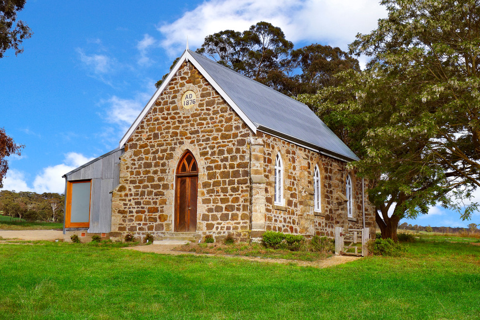 Design ideas for a country exterior in Sydney with metal siding and a gable roof.