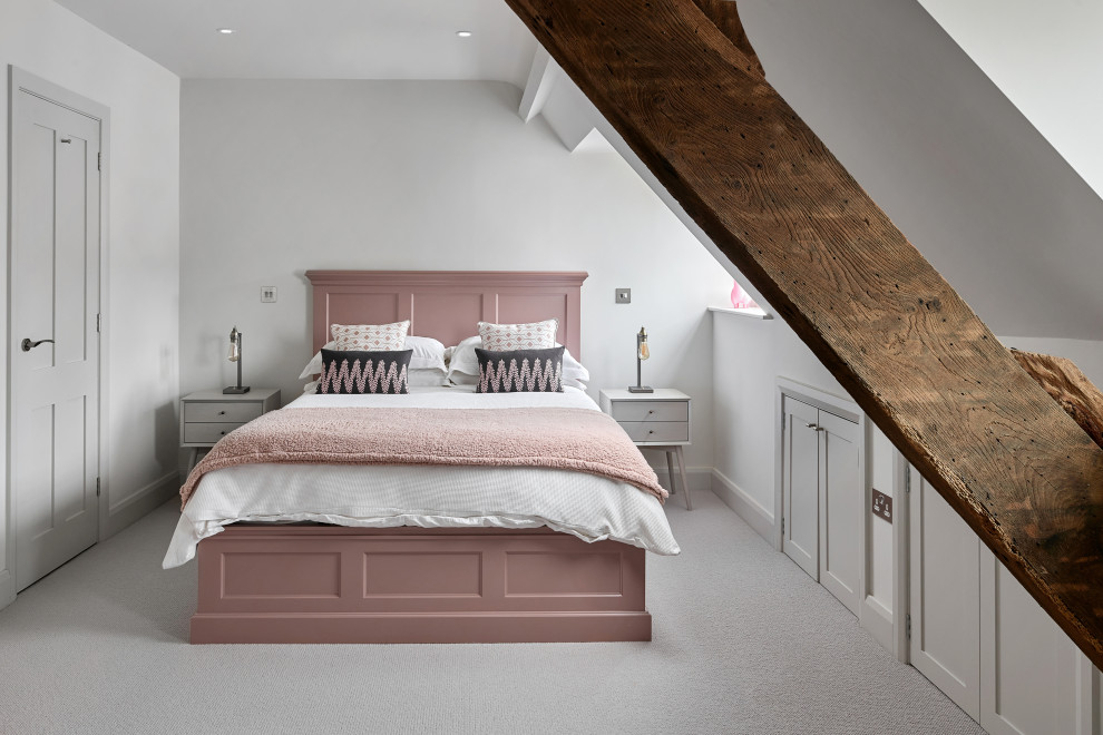 Design ideas for a mid-sized transitional kids' room for girls in West Midlands with white walls, carpet and grey floor.