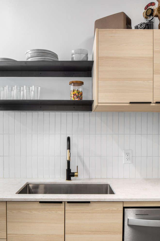 Inspiration for a modern single-wall concrete floor, gray floor and exposed beam eat-in kitchen remodel in Phoenix with flat-panel cabinets, light wood cabinets, quartzite countertops, no island, white backsplash, ceramic backsplash and white appliances