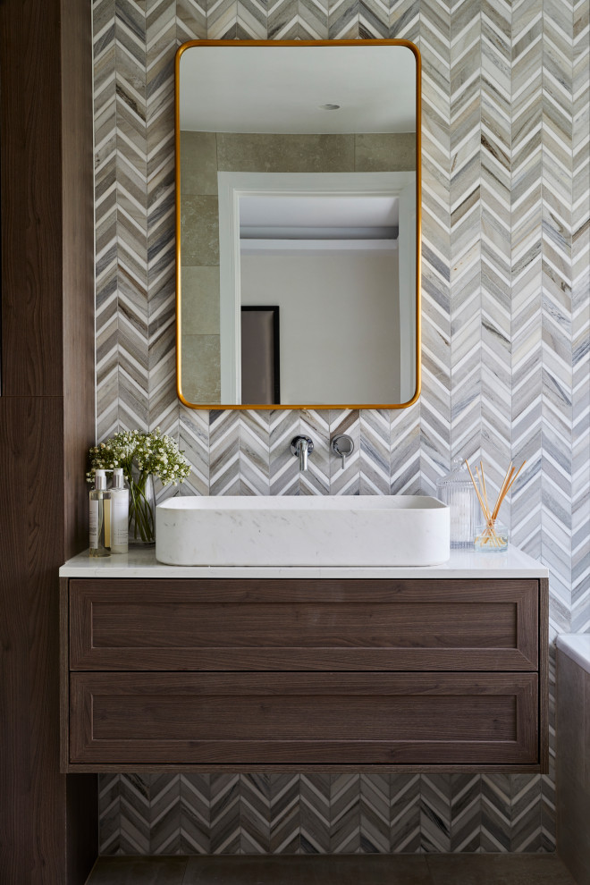 Design ideas for a mid-sized modern master bathroom in London with shaker cabinets, brown cabinets, an open shower, a wall-mount toilet, brown tile, porcelain tile, brown walls, porcelain floors, a vessel sink, marble benchtops, brown floor, a hinged shower door, grey benchtops, a single vanity and a floating vanity.