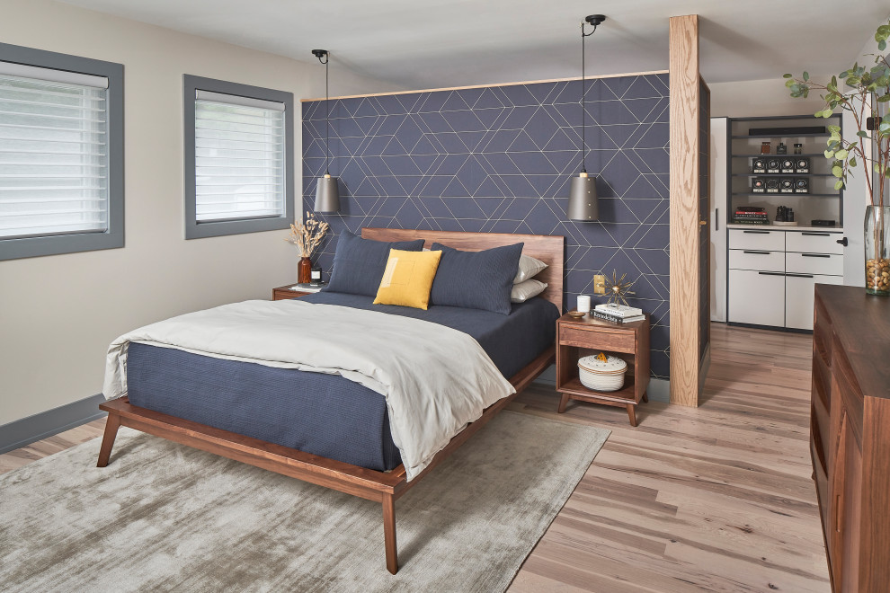 Design ideas for a mid-sized midcentury master bedroom in Charlotte with white walls, light hardwood floors, brown floor and wallpaper.