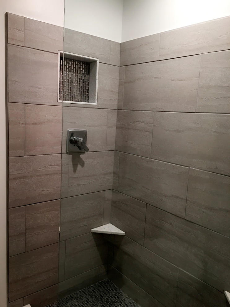 Example of a mid-sized transitional white tile and porcelain tile porcelain tile and beige floor freestanding bathtub design in Detroit with louvered cabinets, white cabinets, a two-piece toilet, an undermount sink, solid surface countertops and beige walls