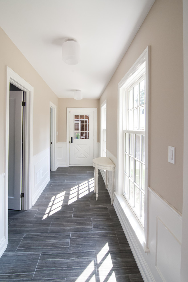 Design ideas for a large arts and crafts hallway in Other with beige walls and porcelain floors.