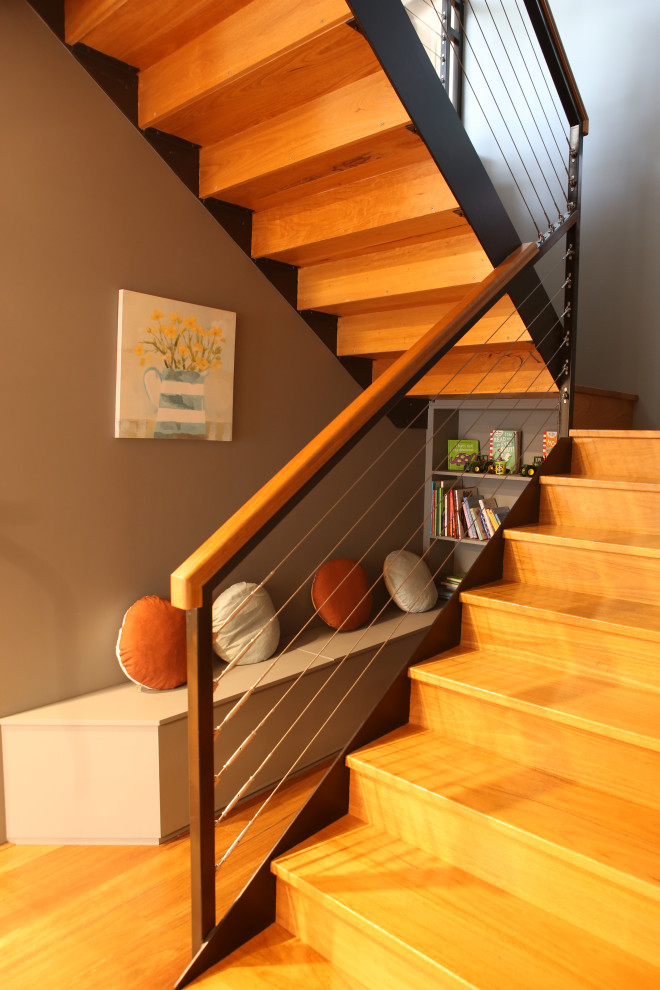 Idées déco pour un escalier droit de taille moyenne avec des contremarches en bois et un garde-corps en métal.