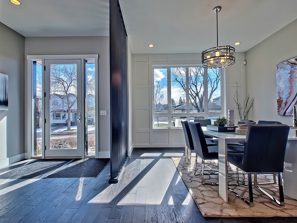 Mid-sized modern entry hall in Calgary with white walls, painted wood floors, a single front door and a glass front door.