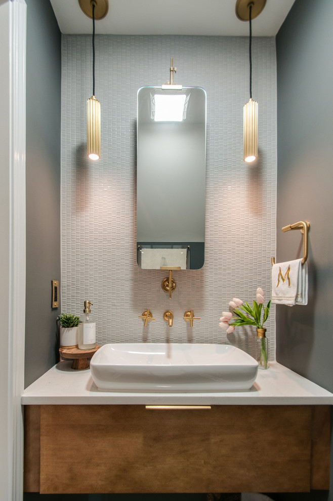 Inspiration for a small mid-century modern gray tile and porcelain tile medium tone wood floor powder room remodel in Nashville with furniture-like cabinets, brown cabinets, a one-piece toilet, gray walls, a vessel sink, quartz countertops, white countertops and a floating vanity