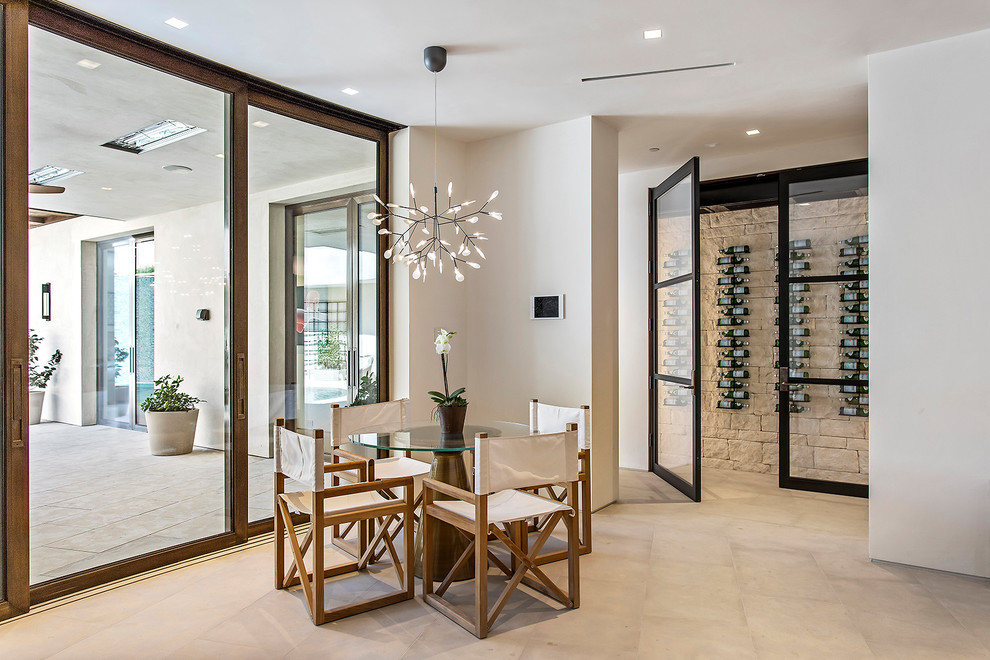 Photo of a large contemporary wine cellar in Los Angeles with porcelain floors, display racks and beige floor.