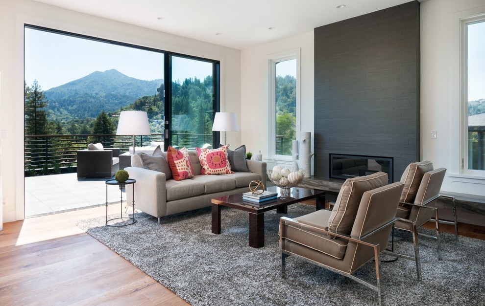 Design ideas for a contemporary formal open concept living room in San Francisco with white walls, medium hardwood floors, a ribbon fireplace and a tile fireplace surround.