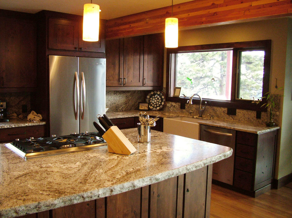 Example of a large mountain style u-shaped medium tone wood floor open concept kitchen design in Denver with a farmhouse sink, flat-panel cabinets, dark wood cabinets, granite countertops, gray backsplash, stainless steel appliances and an island