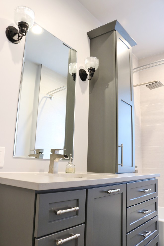 Home design - mid-sized transitional 3/4 beige tile and ceramic tile ceramic tile and gray floor home design idea in Chicago with shaker cabinets, gray cabinets, a one-piece toilet, gray walls, an undermount sink, quartz countertops and gray countertops