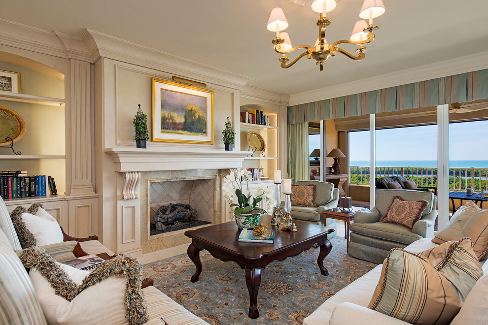 This is an example of a traditional living room in Miami with beige walls and a standard fireplace.
